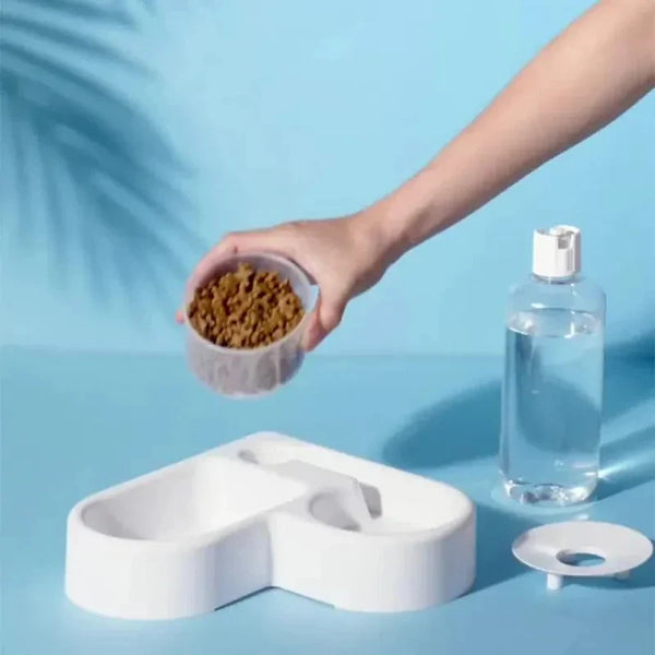 Automatic drinking love pet bowl with dual feeding and water use on a blue background.