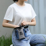 Dog outdoor training bag in use, attached to a person's waist, ideal for carrying pet treats during training sessions.
